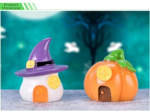 Macro view of miniature resin Halloween witch house and pumpkin cottages for micro landscape