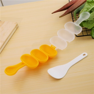 Close-up of three-hole rice ball maker with handle and plastic scoop on wooden table