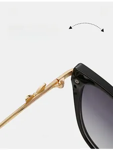 Macro shot of durable golden metal hinges on cat-eye sunglasses with purple gradient lenses