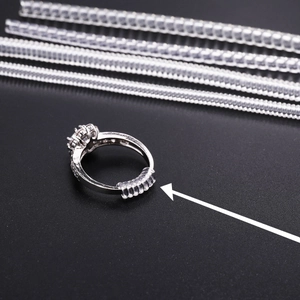 Invisible clear spiral ring size adjuster set for loose rings on textured background