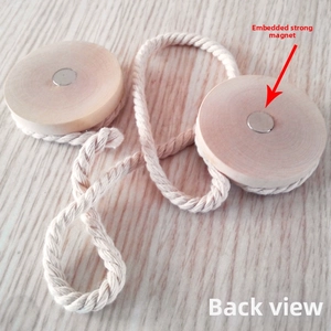 Detail of wooden magnetic curtain tieback showing strong embedded magnets and cotton rope