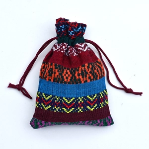 Close-up of ethnic cotton drawstring pouch with colorful stripes and geometric patterns