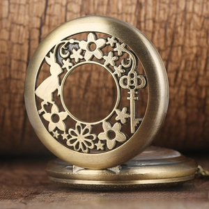 Close-up of vintage bronze hollow pocket watch with rabbit and key carvings on wood