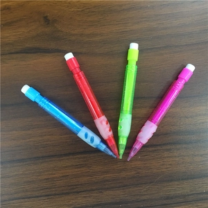 Close-up of mini mechanical pencils in vibrant colors with top erasers on wood surface