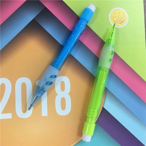 Close-up of blue and green mini mechanical pencils with anti-slip rubber grips