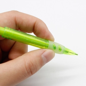 Close-up of mini green mechanical pencil featuring a transparent soft ergonomic rubber grip