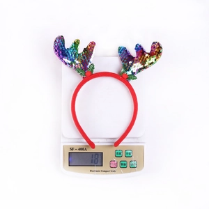 Detail shot of a 18g sequined Christmas reindeer antler headband on a scale