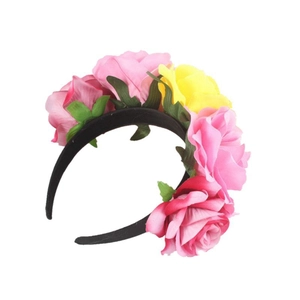 Detail of pink and yellow fabric roses on a black headband for Halloween party wear