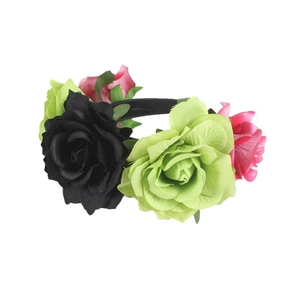Detail of velvet rose headband with large black, light green and pink flowers