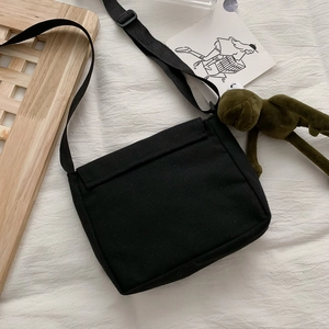 Black canvas messenger bag with planet print and adjustable strap in high-capacity style