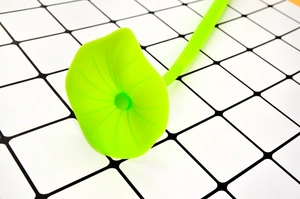 Macro detail of green silicone lotus leaf pen topper showing realistic vein textures