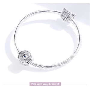 Detailed macro of a S925 silver charm bracelet featuring a blue star bead and cat clasp