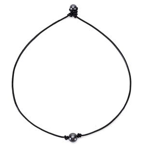 Detail of handcrafted leather necklace with black pearl pendant and toggle closure