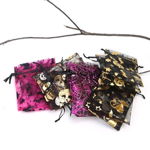Detail of Halloween drawstring organza bags with gold foil spider web and skull patterns