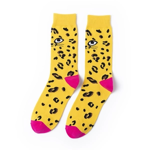 Detail view of yellow cotton socks featuring leopard print and cat face patterns