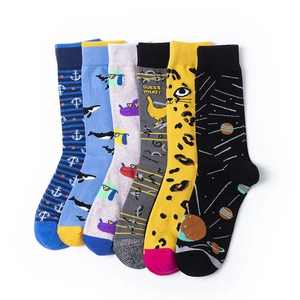 Close-up of six colorful patterned mid-calf socks featuring whales and cartoon graphics