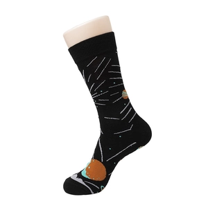 Detail view of black mid-calf socks with space planet patterns on a display foot