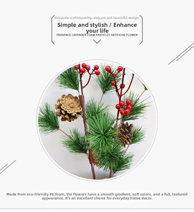 Close-up of artificial pine needles with red berries and pine cones for Christmas decor