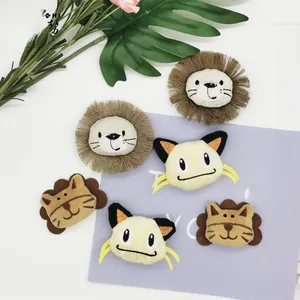 Detail of plush cartoon animal badges including lion, cat and bear embroidery accessories
