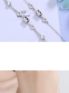 Detailed view of silver minimalist cylinder bead and ring link on a delicate chain