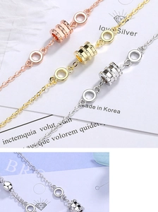 Detailed view of rose gold, gold and silver spiral bracelets on an elegant background
