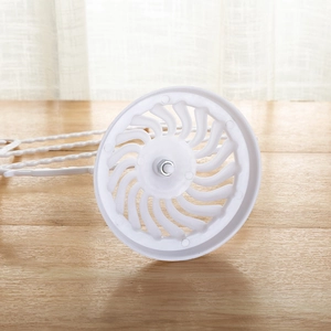 Detailed view of the white plastic base with hollow swirl pattern and metal screw