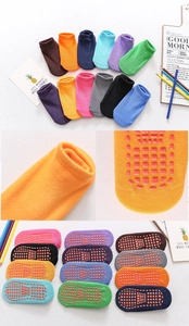 Macro detail of anti-slip silicone grip dots on colorful low-cut children socks