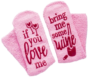 Pink fuzzy socks featuring 'if you love me bring me some wine' printed text and patterns