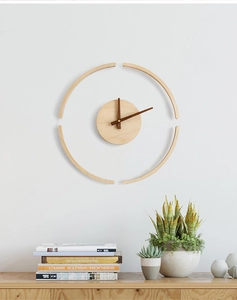 Detail of creative wooden wall clock showing natural wood grain and minimalist hands