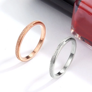 Close-up of matte finished rose gold and silver minimalist metal rings set