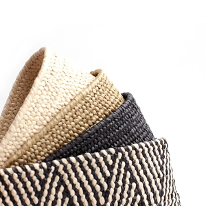 Women's woven straw belts in beige, black and herringbone patterns with round buckle design