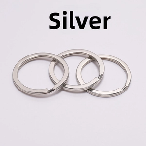 Close-up of three flat chrome metal split rings for DIY keychain crafts and accessories