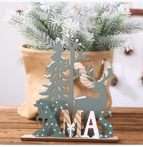 Detail of wooden XMAS tabletop ornament featuring reindeer and pine tree cutout shapes