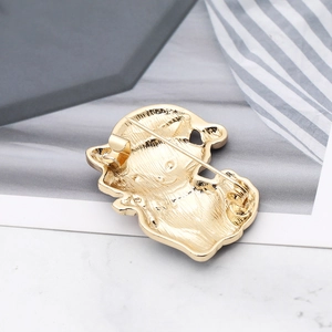 Macro detail of the gold-plated alloy brooch back showing a secure safety pin fastener