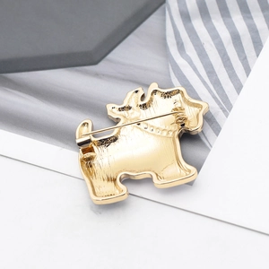 Detailed back view of golden dog brooch showing the secure pin fastener and metallic shine