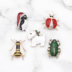Set of colorful enamel animal brooches featuring penguin, bee, ladybug, and dog designs