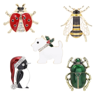 Close-up of enamel animal brooches including ladybug, bee, penguin, dog, and beetle