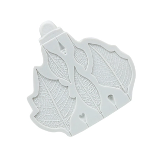 Close-up of light gray silicone mold showing detailed leaf vein texture for fondant cakes