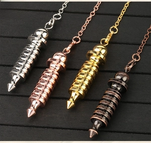 Macro shot of spiral dowsing pendulums in silver, gold, rose gold and black finishes