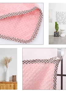 Close-up of pink pineapple texture absorbent towel with brown checkered piping details