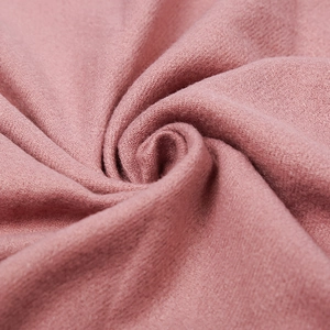 Pink cashmere-feel solid scarf featuring soft woven texture and elegant fringe details