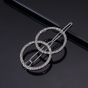 Detailed view of silver interlocking circle hair clip with sparkling rhinestones decoration