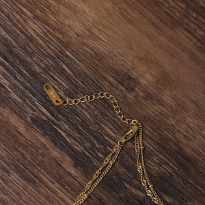 Macro detail of 18K gold lobster clasp and adjustable chain on a vintage necklace