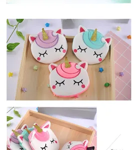 Detailed set of three plush unicorn coin purses in pastel pink, purple and mint green colors