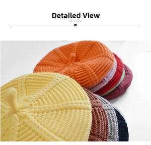 Detailed macro view of multi-colored knitted pumpkin berets showing thick ribbed texture