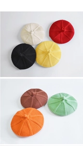 Close-up of kids knitted beret showing various vibrant colors and textured weave details