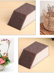 Detail of a trapezoidal emery sponge showing brown abrasive side and white foam layer
