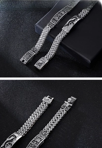 Detail of silver stainless steel keel bracelet with industrial gear links and engraved clasp