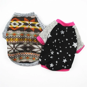Detail view of ethnic pattern and star print fleece dog sweaters on white background