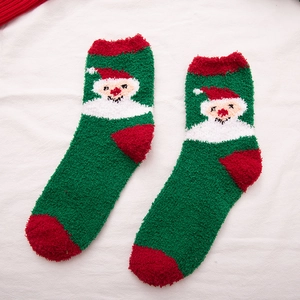 Green coral fleece Christmas socks featuring a festive Santa Claus pattern for winter warmth